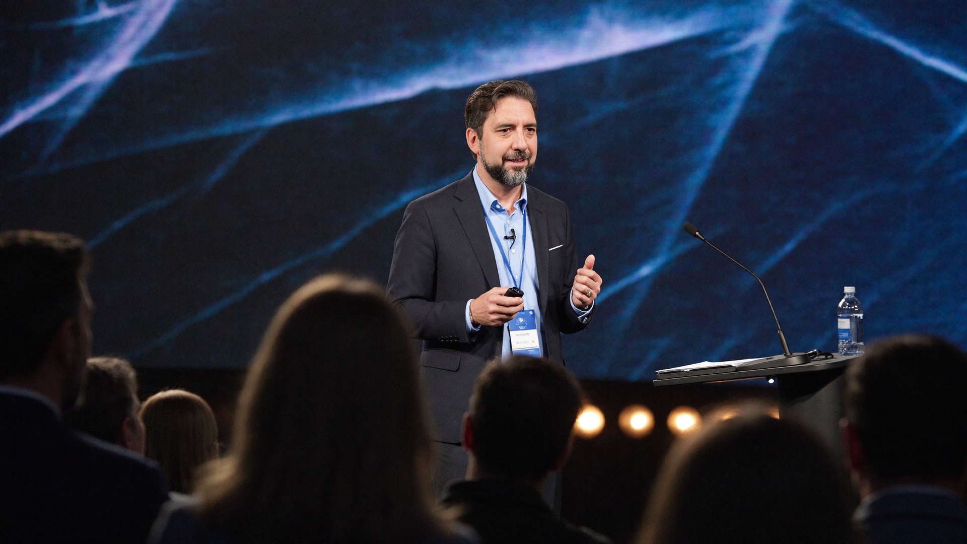 Reza Taghawi speaking on a conference stage